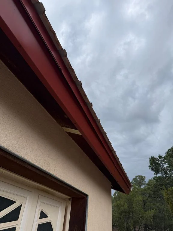 Garage eave with red metal fascia