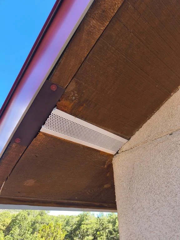 Same soffit section patched with white aluminum soffit vent