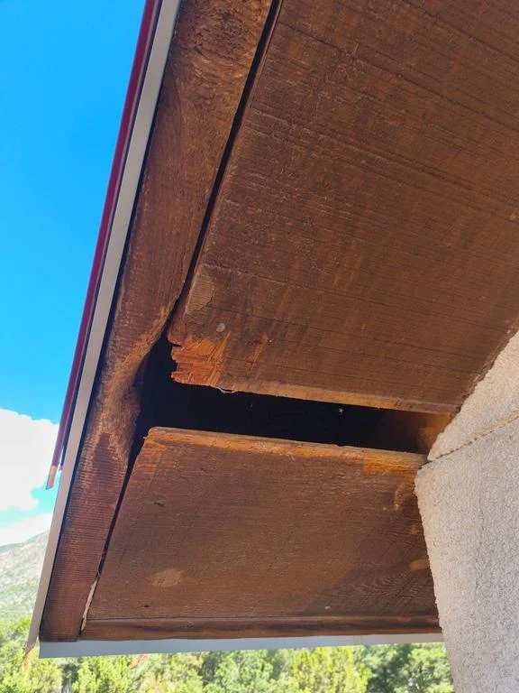 Broken soffit section with an open gap before repair