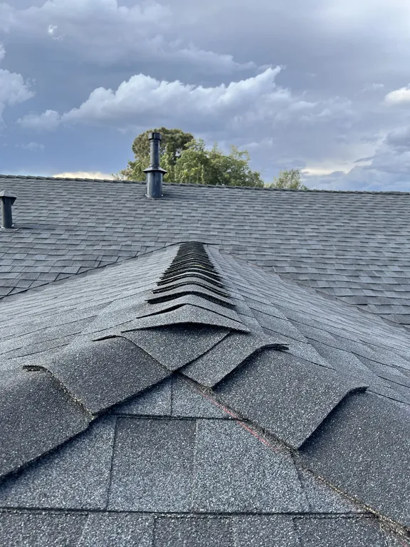 Close-up of new GAF ridge cap shingles where three hips meet