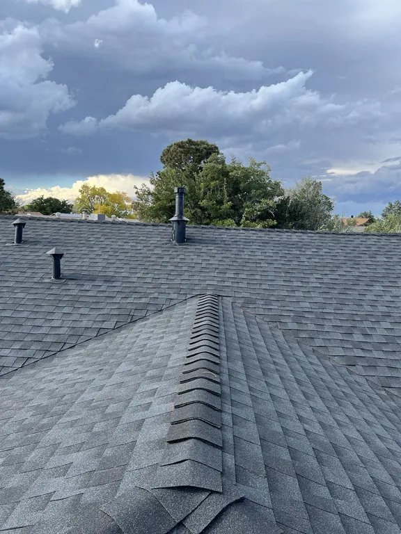 Finished hip ridge with new GAF ridge cap shingles and black roof vents