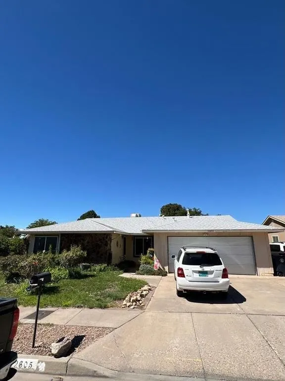 Front of the Southeast Albuquerque home with its original light gray shingle roof