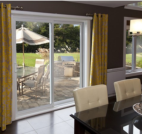 Climate Solutions 9000 Series sliding patio door installed off a dining room, opening to a patio