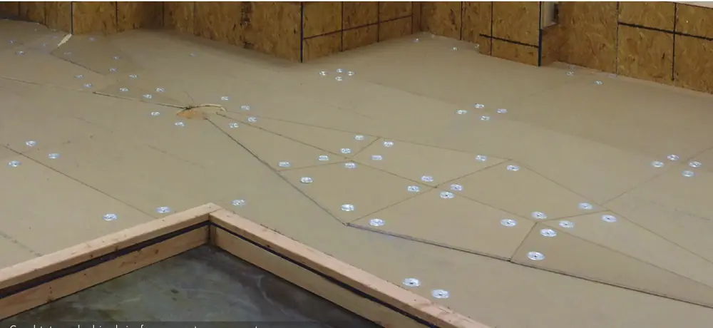 Tapered polyiso insulation boards fastened to a roof deck to create slope to a drain