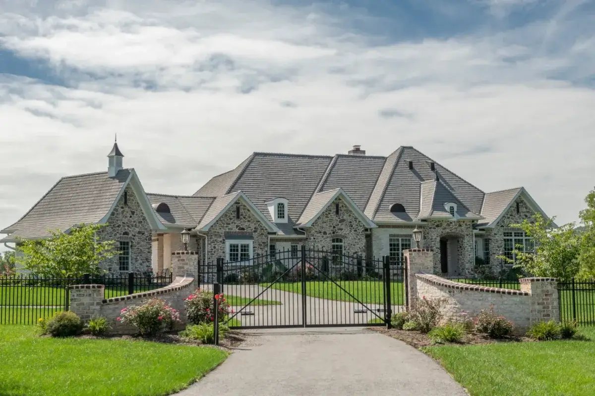 Stone French country home with an Enviroshake Aged Cedar roof