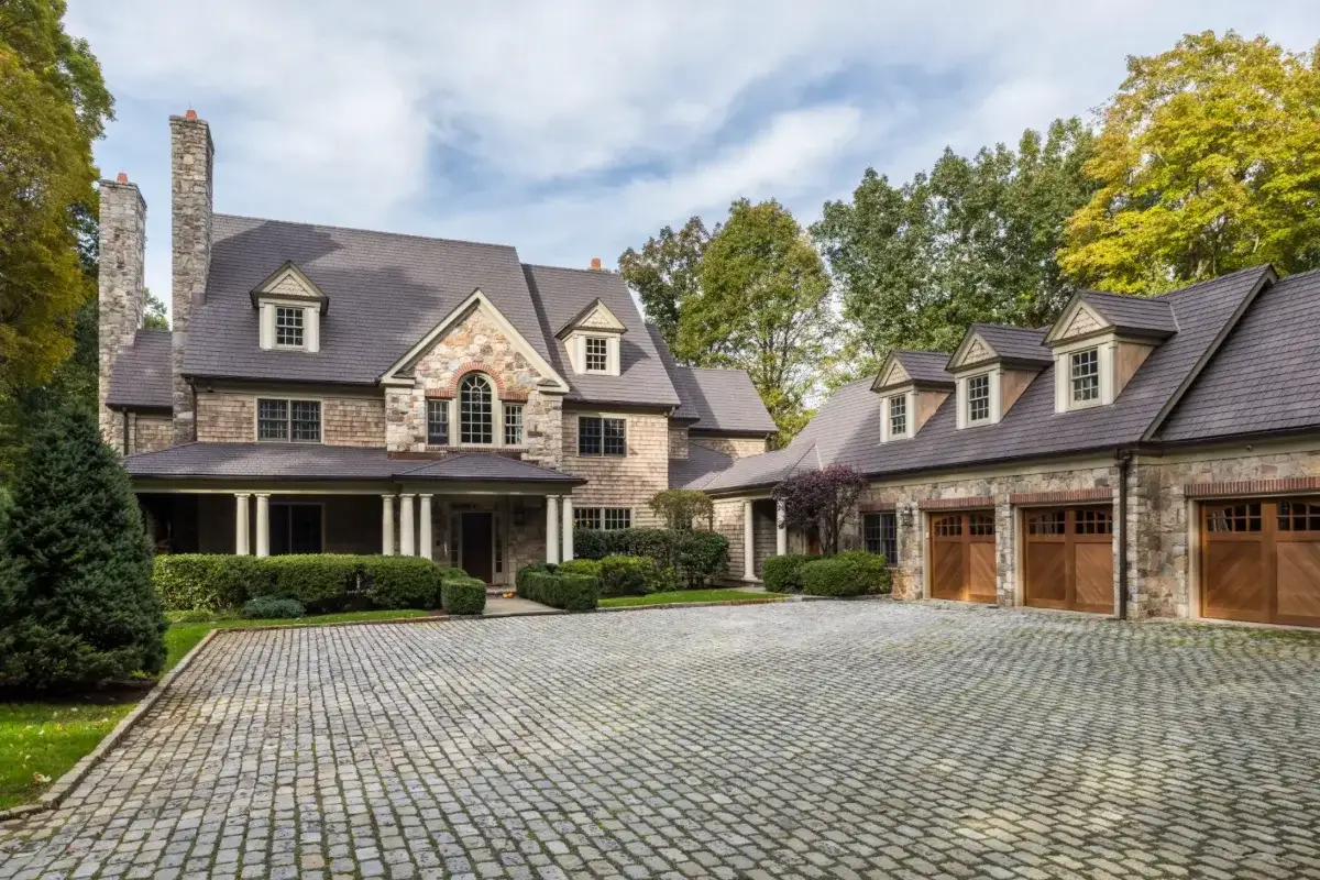 Stone home with dormers and an Enviroshake Aged Cedar roof