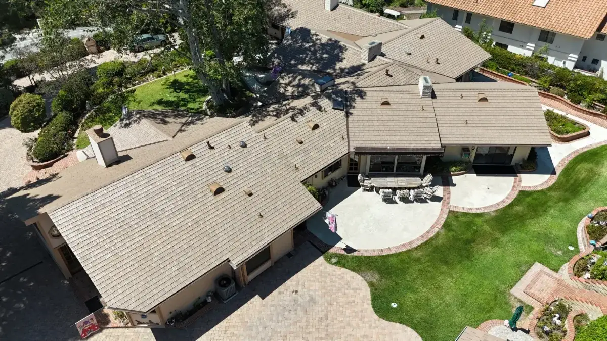 Aerial view of a sprawling home with an Enviroshake Disney Brown roof
