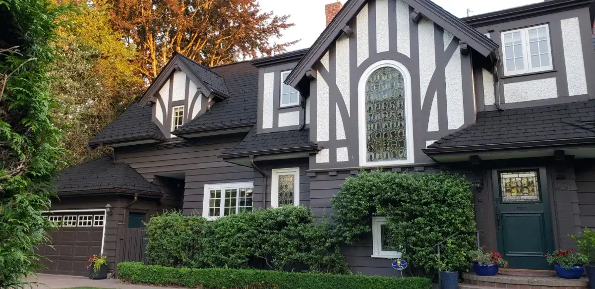 Tudor-style home with an Enviroslate Onyx Black roof
