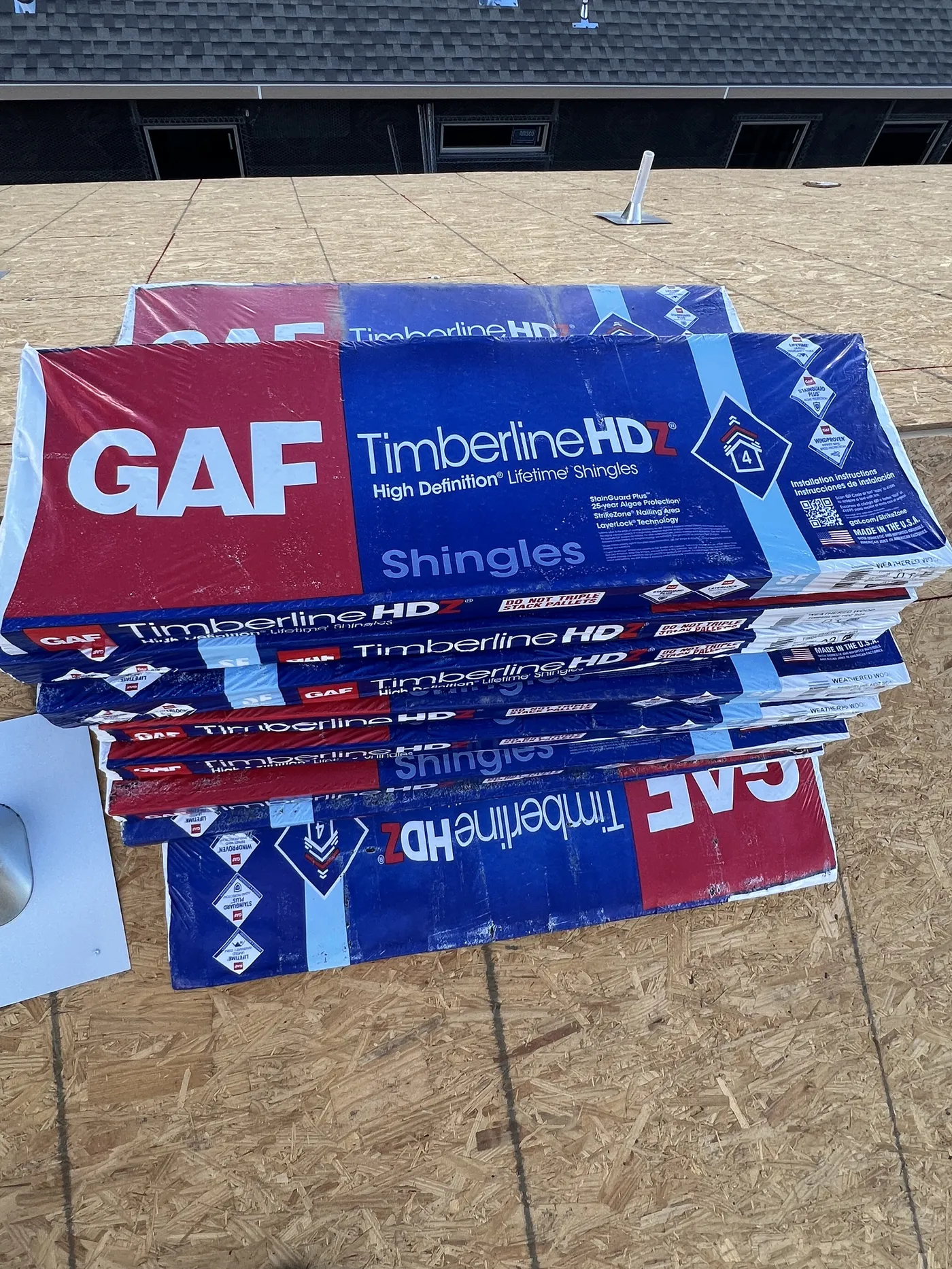 GAF Timberline HDZ shingle bundles staged on a roof deck before installation