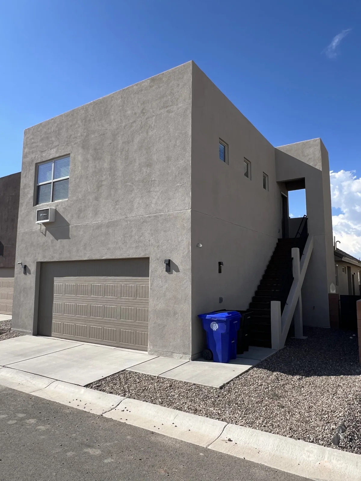 Modern stucco home exterior, ready for roofing
