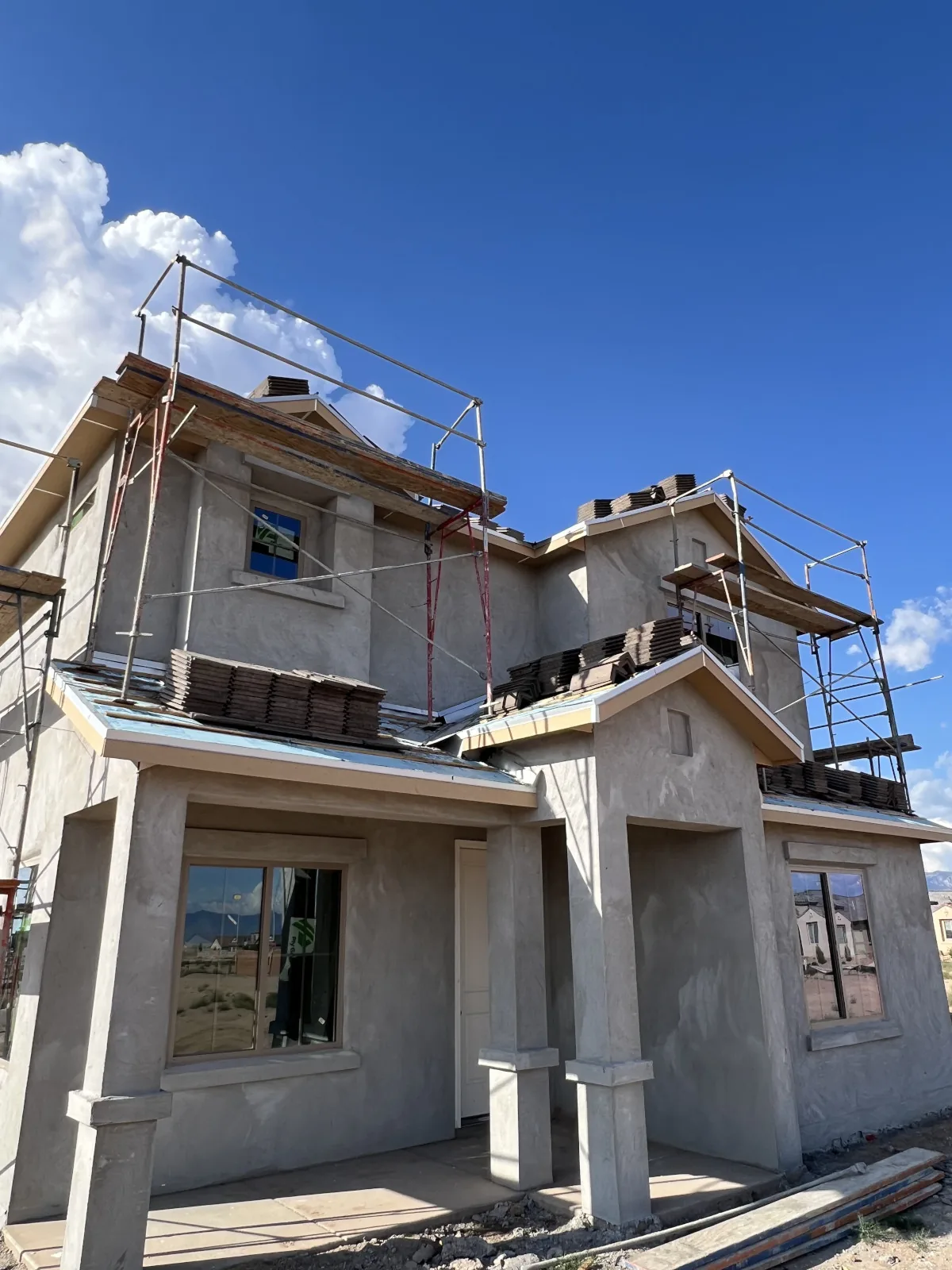 New construction home with scaffolding up before the roof goes on