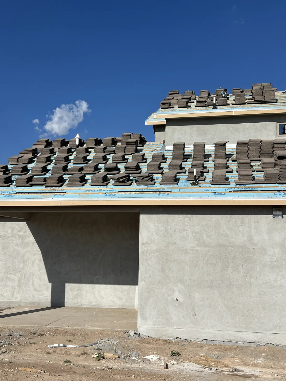 Roof tear-off showing exposed underlayment before new roofing goes down