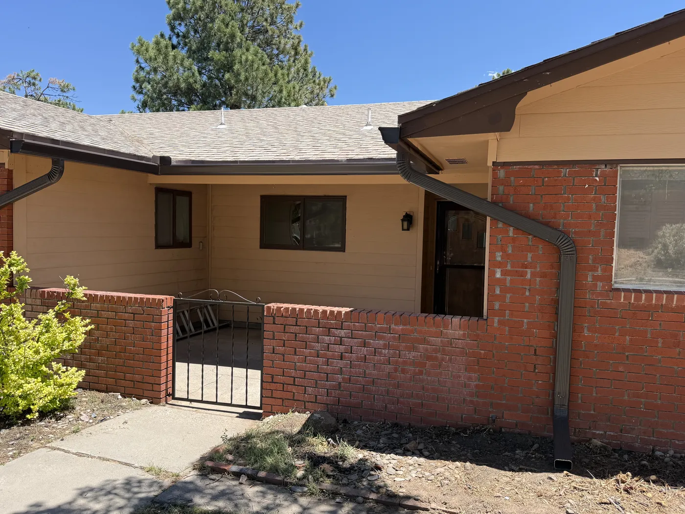Seamless gutter installation on a brick and stucco home