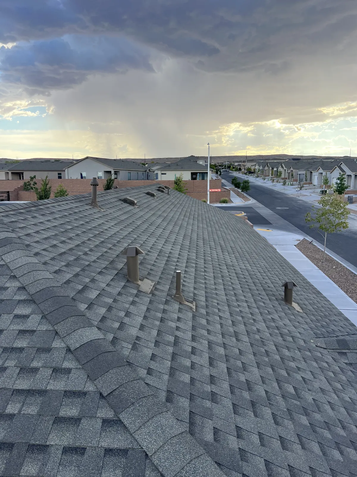 Storm clouds gathering over a residential roof before a monsoon