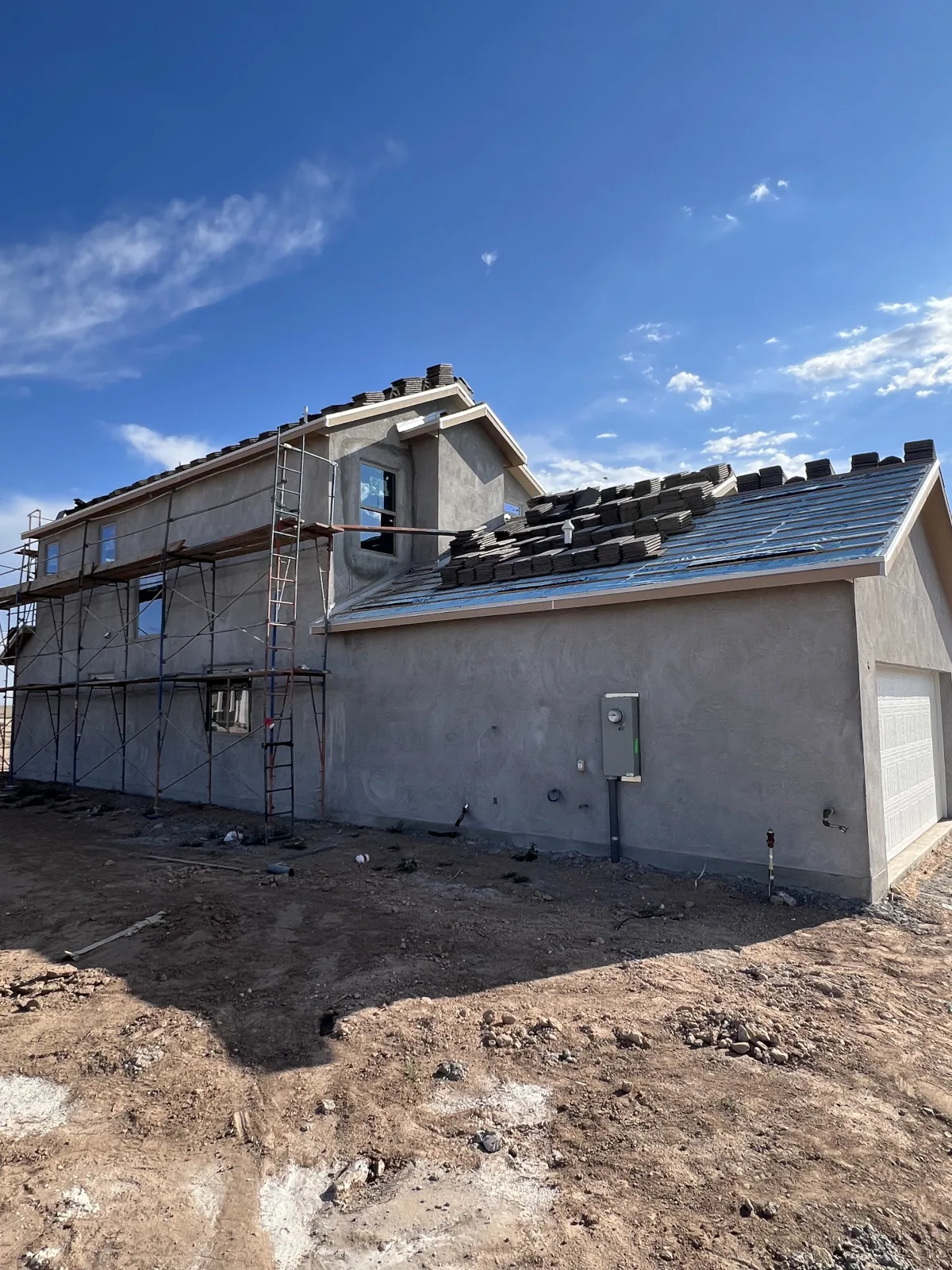 Tile roof mid-installation with the Sandia Mountains in the background