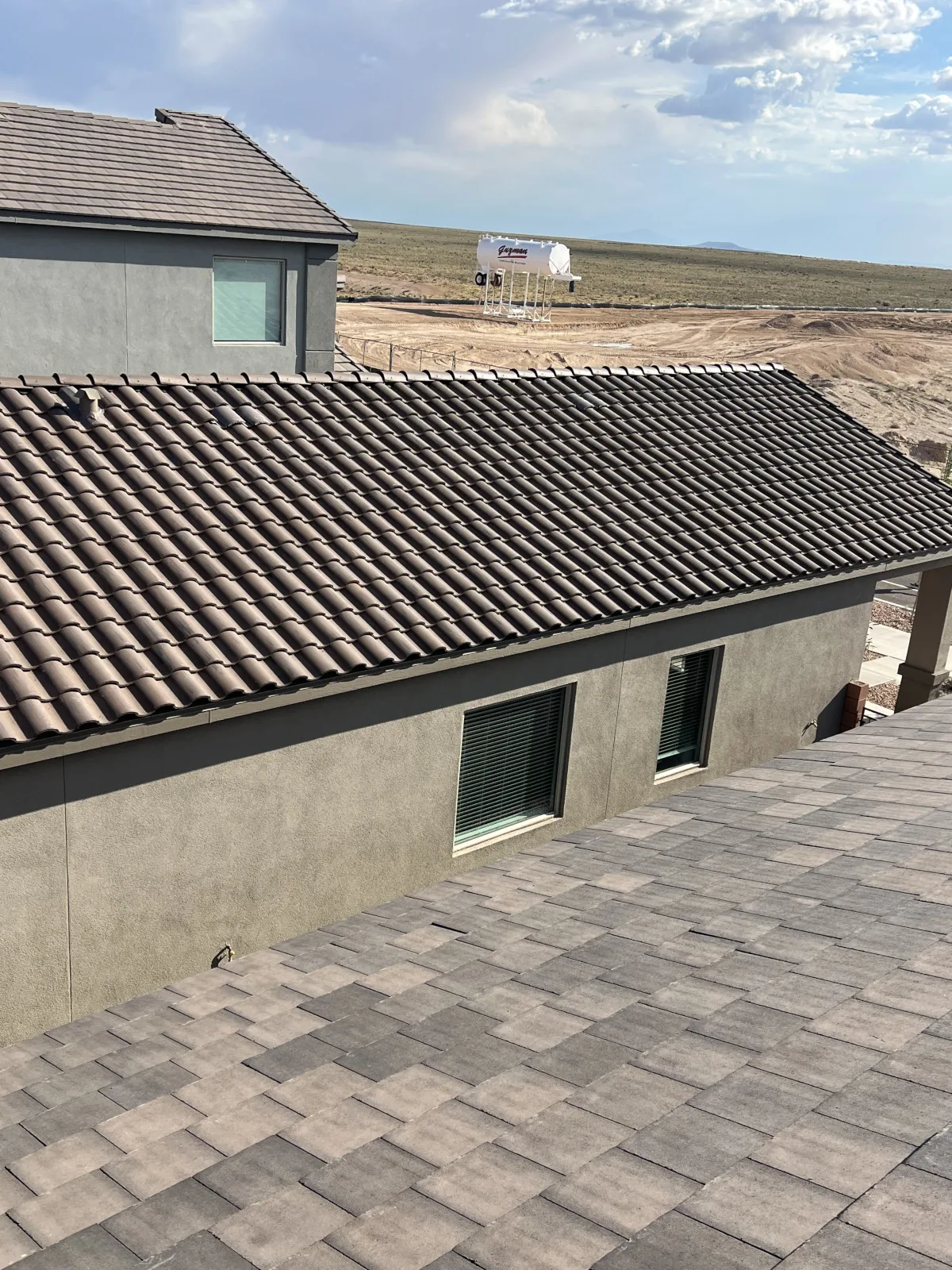 Tile roof with the neighborhood visible in the background