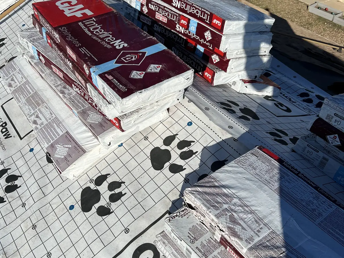 GAF Timberline NS shingle bundles staged on Tiger Paw underlayment during a roof replacement