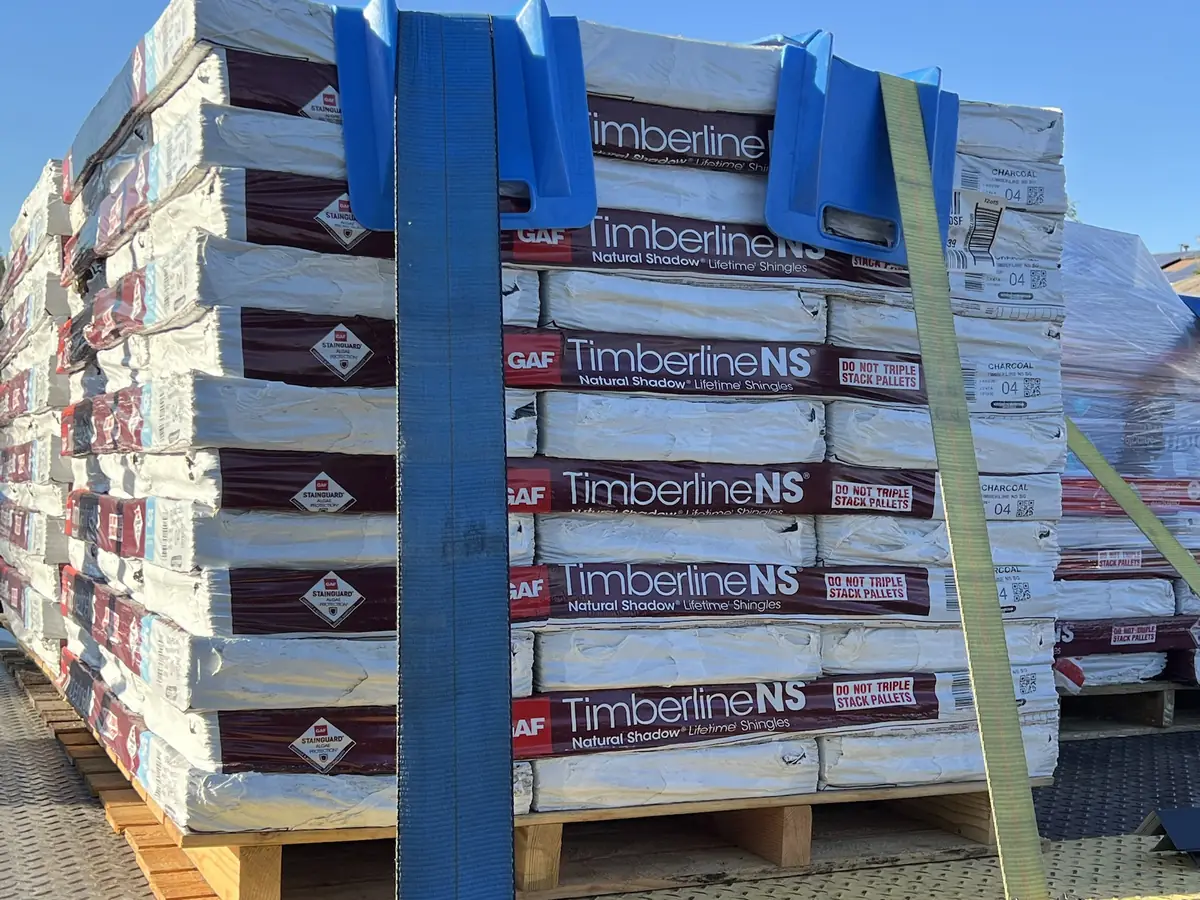 Pallet of GAF Timberline NS Charcoal shingles delivered for a Timberwolf roof replacement