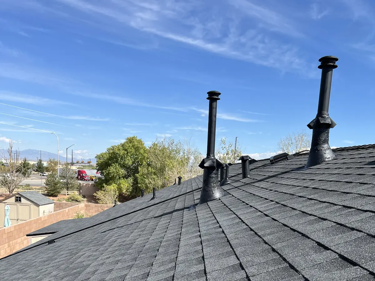 New charcoal architectural shingle roof with pipe vents and flashing