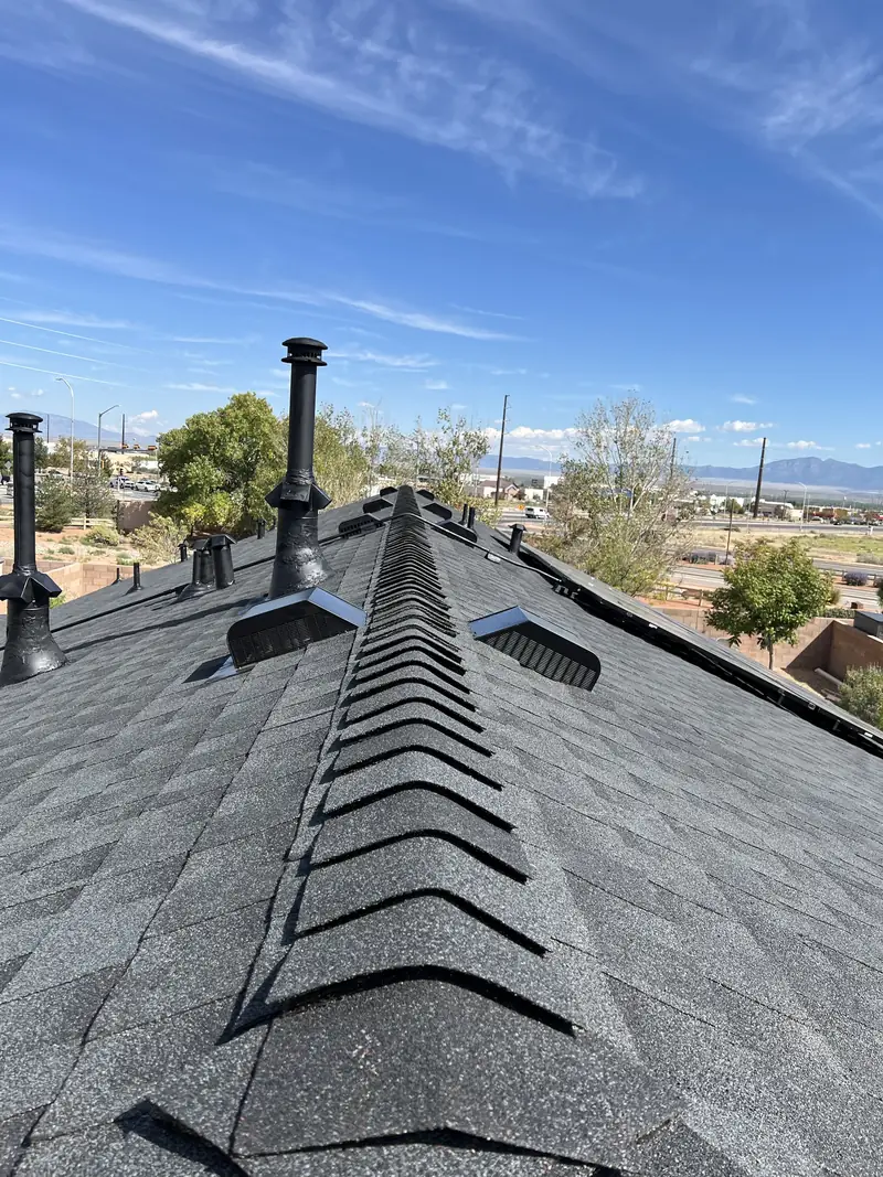 Finished GAF Timberline NS Charcoal roof with new ridge cap and vents on a Los Lunas, NM home