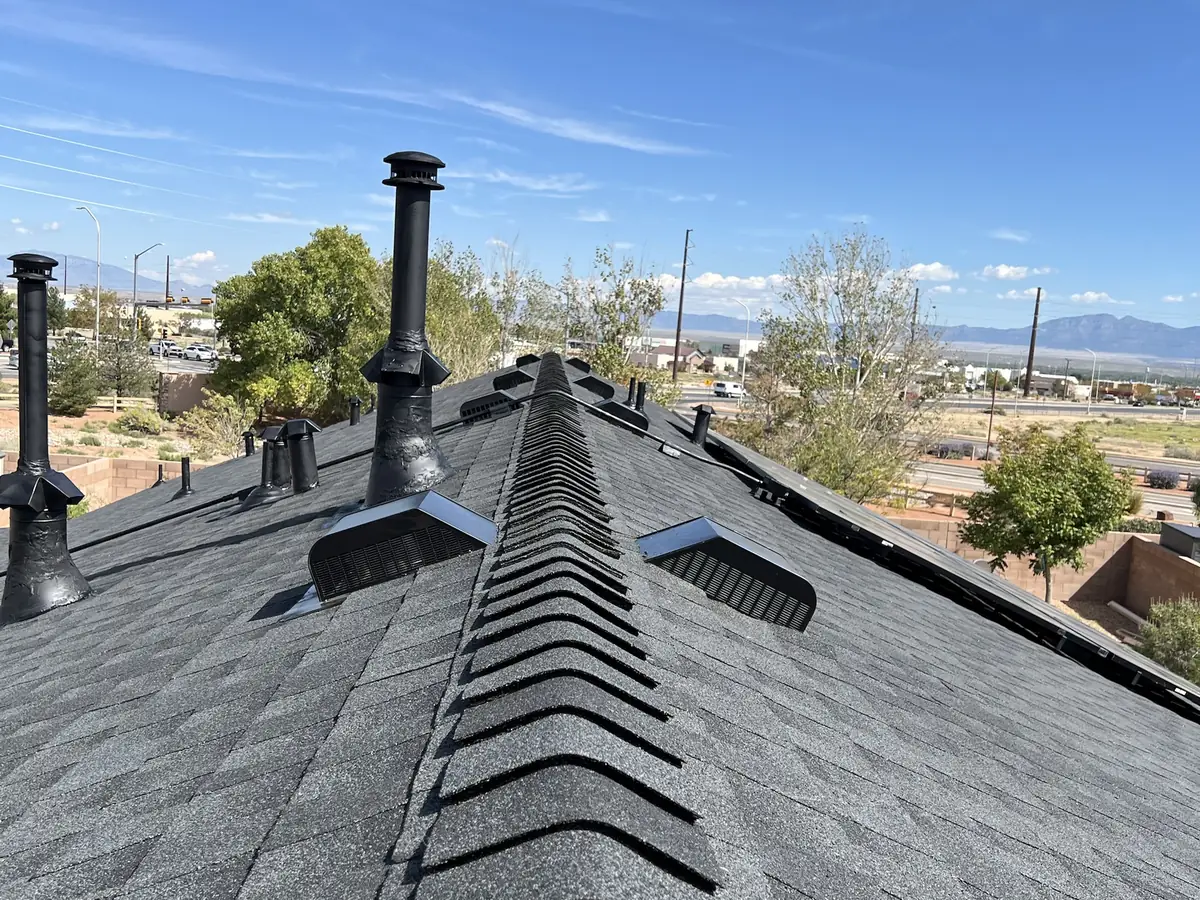 New GAF Timberline NS Charcoal shingle roof with ridge cap and box vents on a Los Lunas home