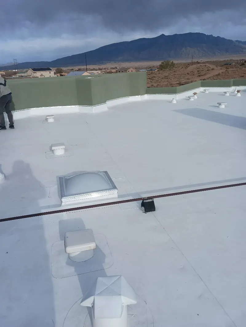 White TPO flat roof with the Sandias behind