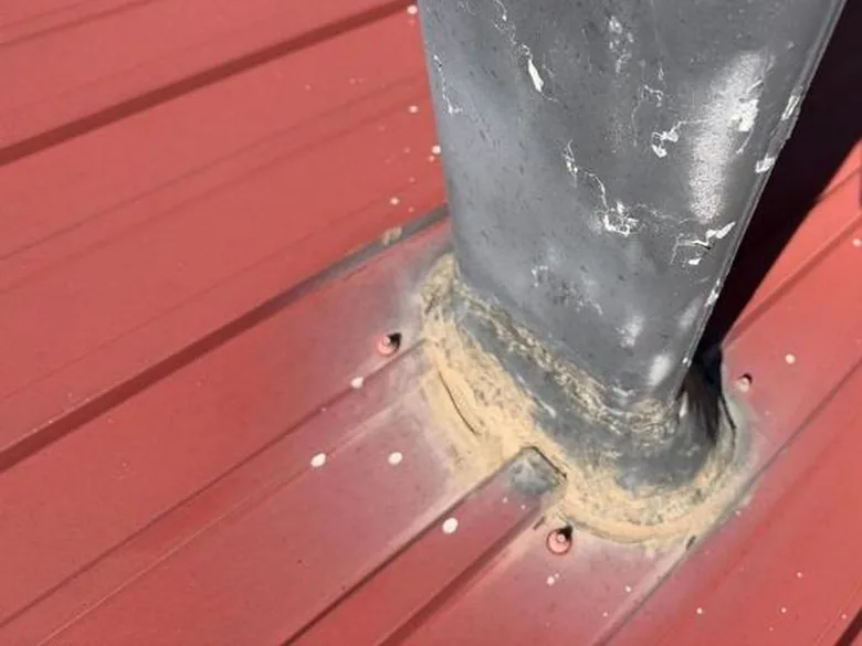 Aging sealant around a pipe penetration on a metal roof